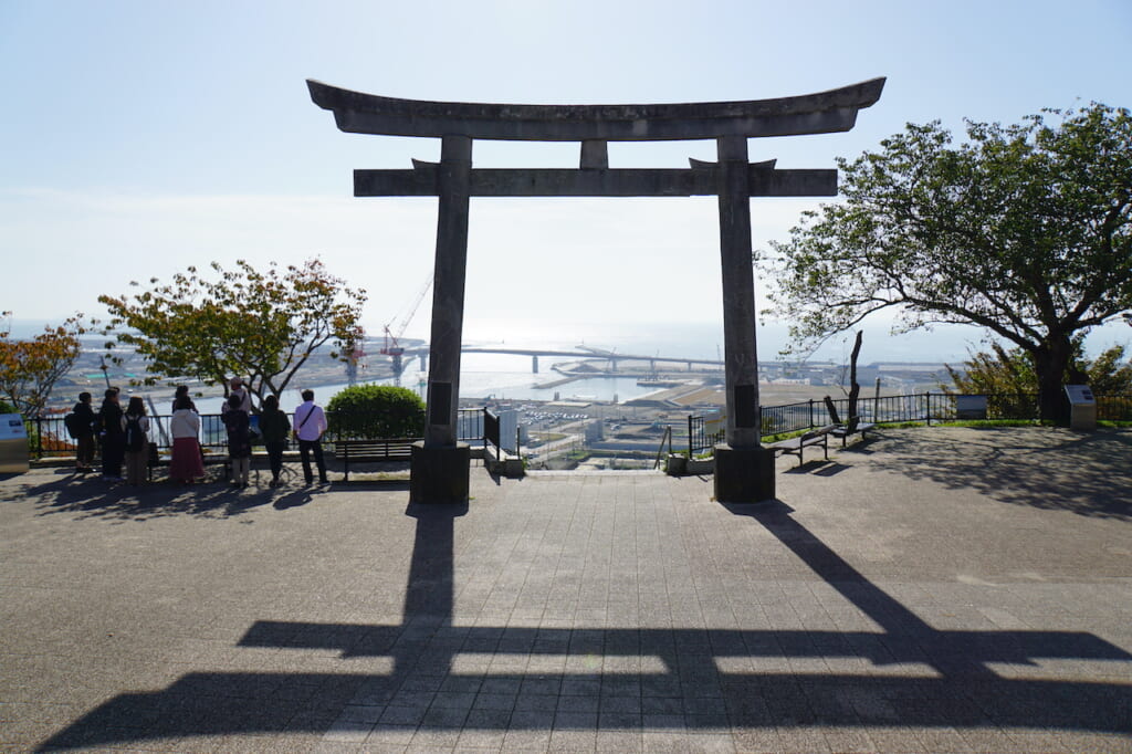 Large Japanese stone torii overlooking bay in Japan