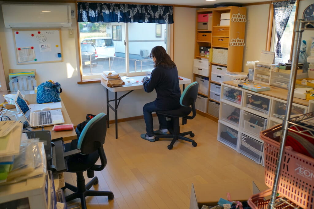 Japanese woman working at desk in trailer