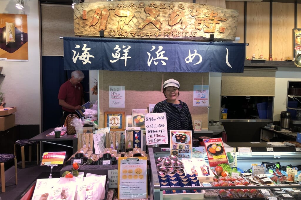 Japanese woman at seafood stall in Japan