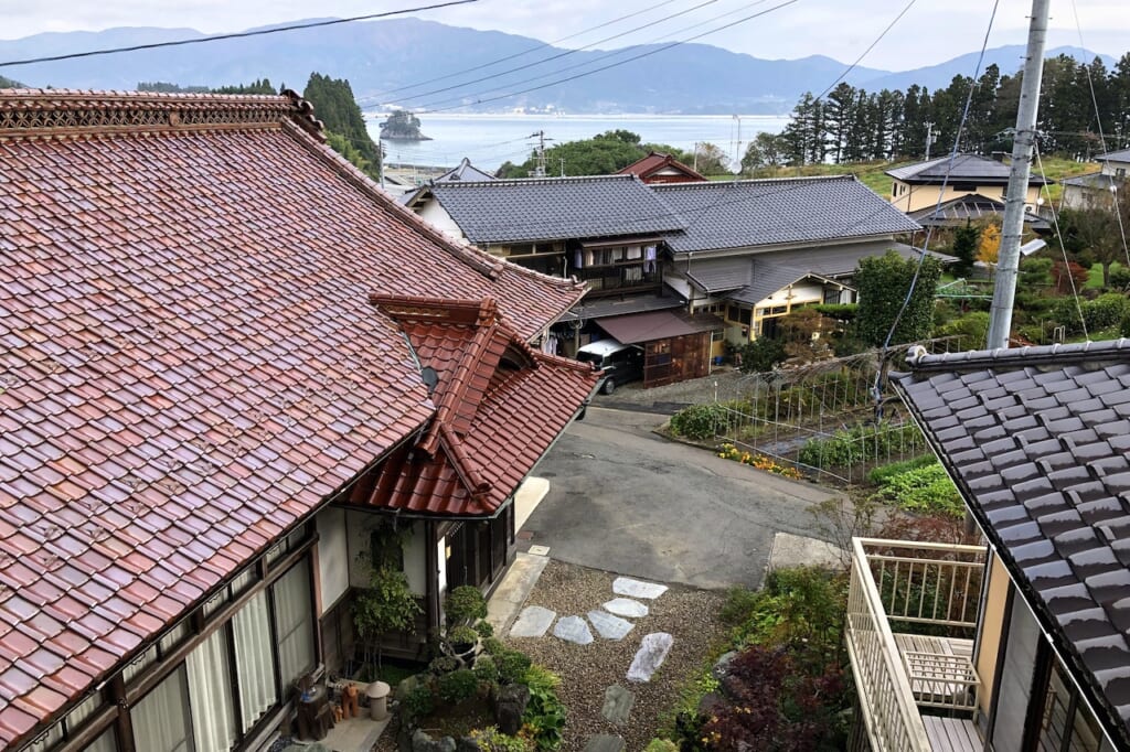 tiled rooftops in front of bay in Japan
