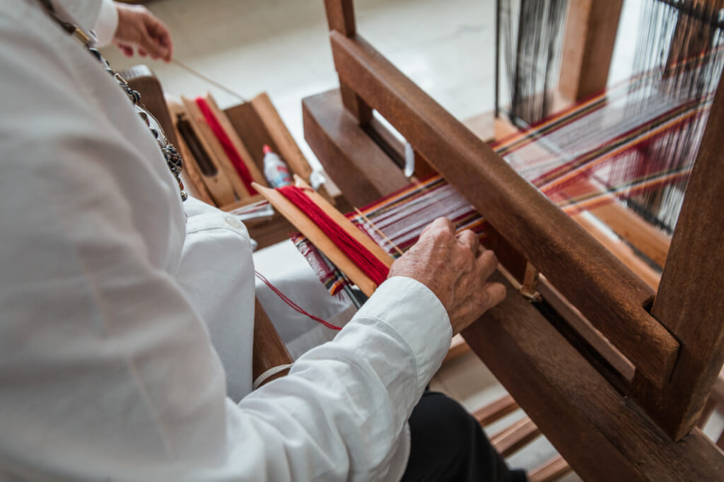 women weaving a japanese textiles