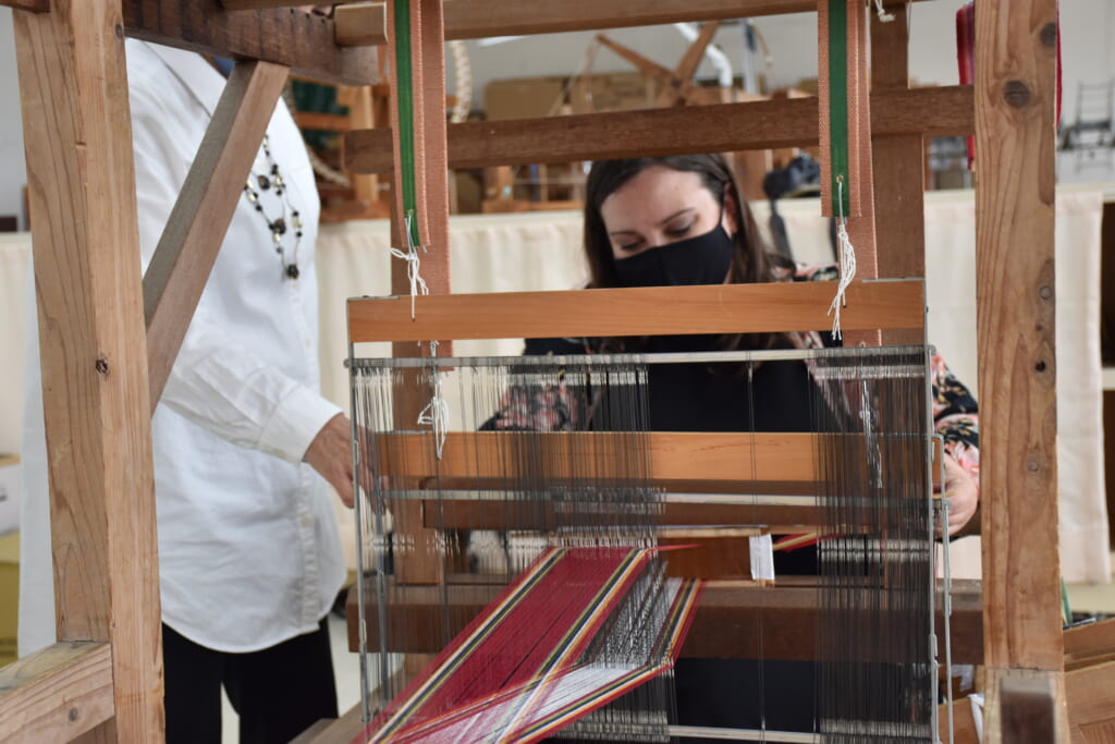 woman weaving hanaori textiles in japan