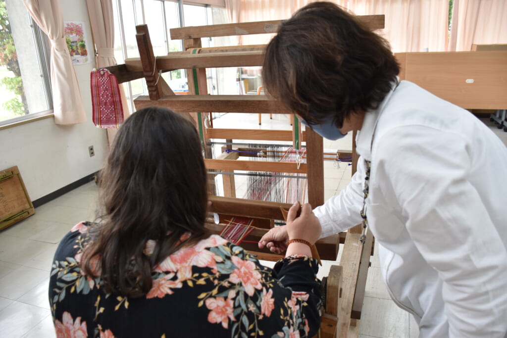 two women using a handloom in japan