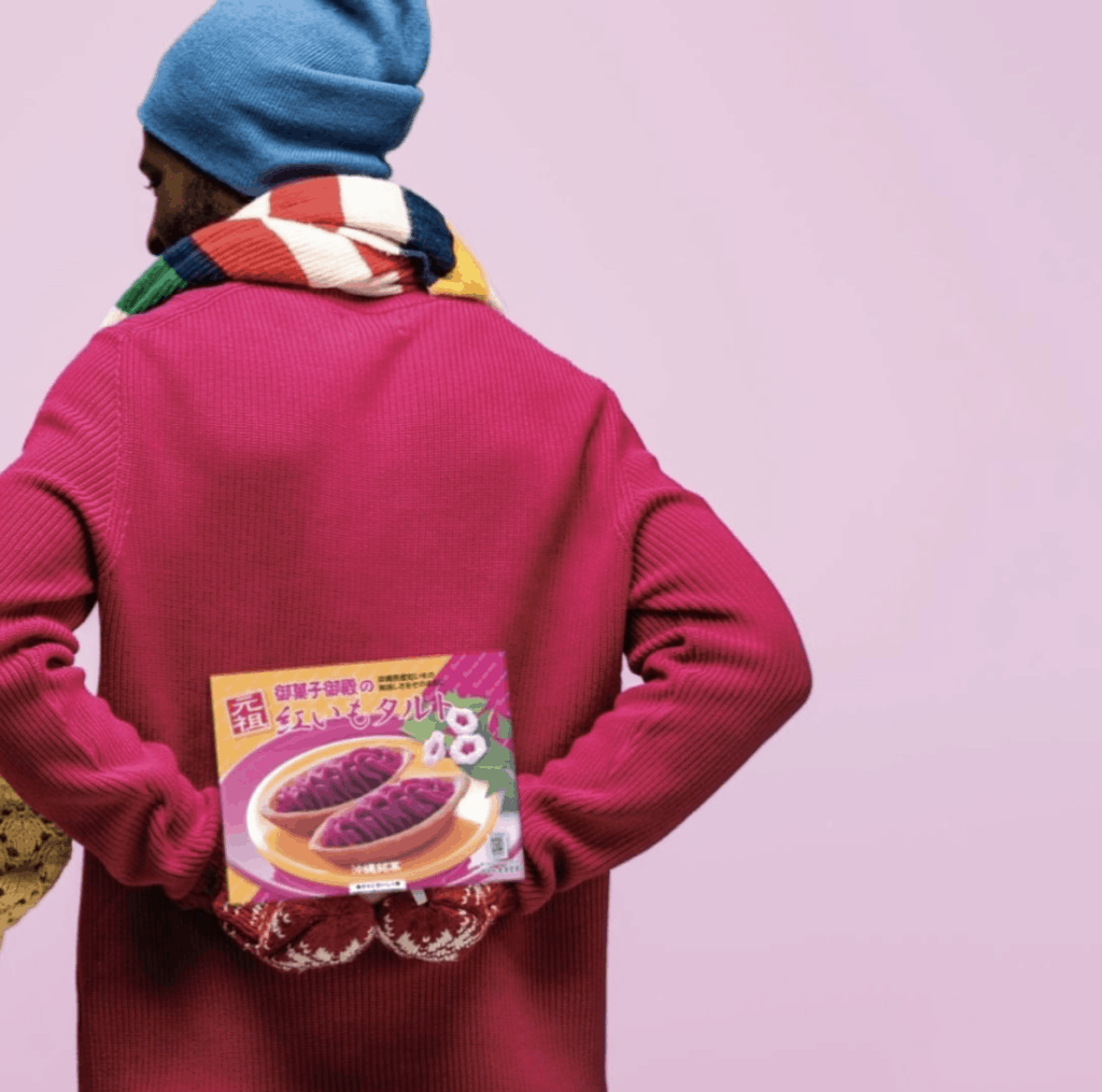 a man holding a Japanese snack box