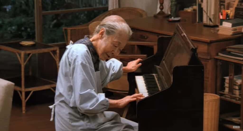 Rhapsody in August, Kane playing piano