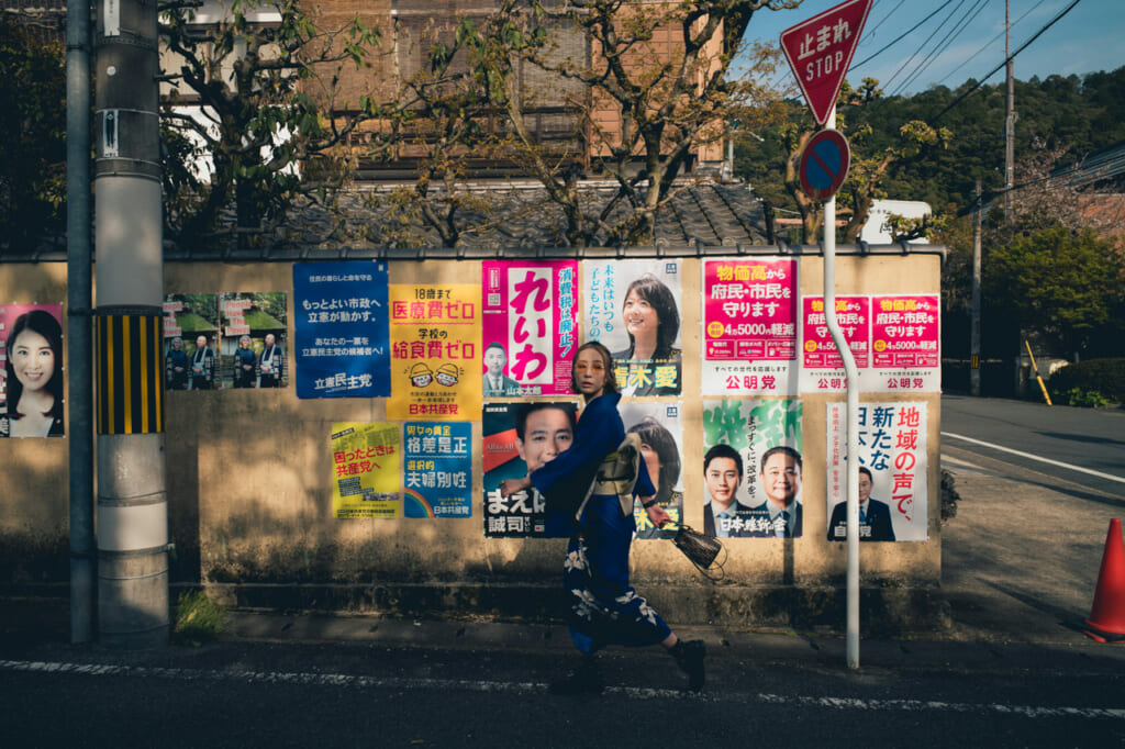 A girl in front of voting posters
