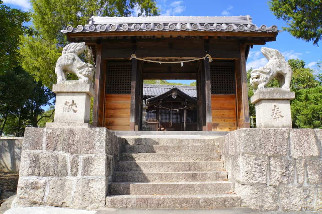 stone guardian lion dogs outside traditional Japanese shrine gate