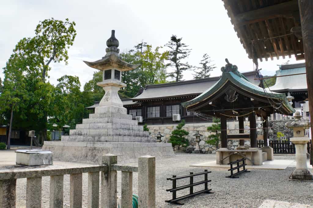 large stone lantern on Japanese shrine grounds along the Kibiji cycling route