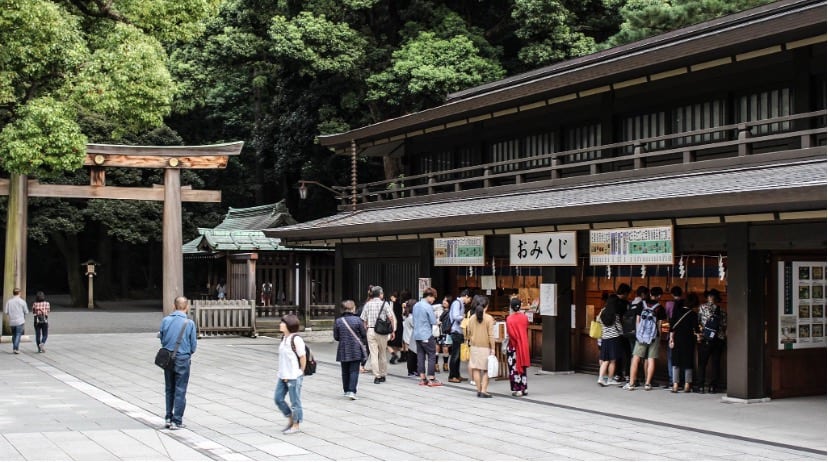 Japanese shrine goers at Meiji Jingu buying Omamori 