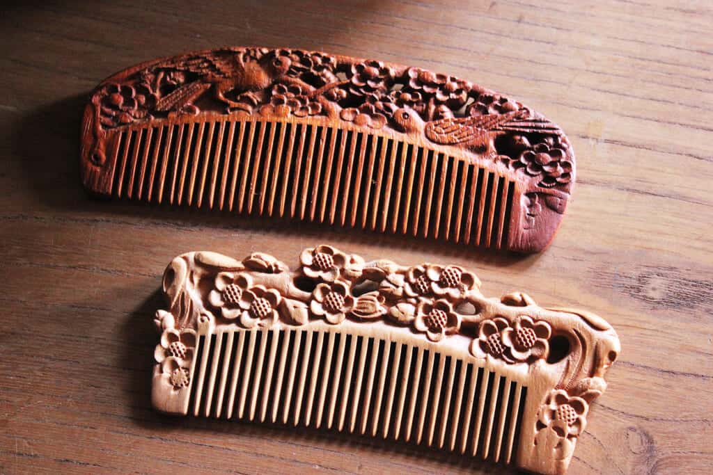 hand-carved wooden combs with birds and flowers patterns