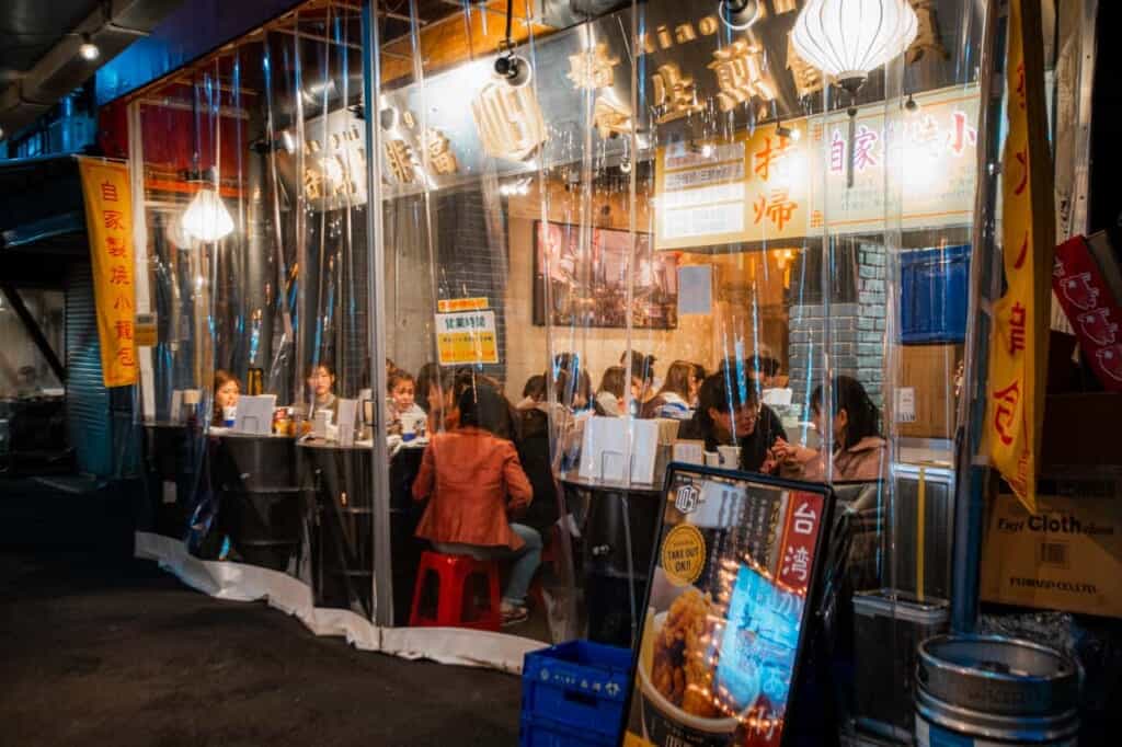 people eating and drinking at a izakaya