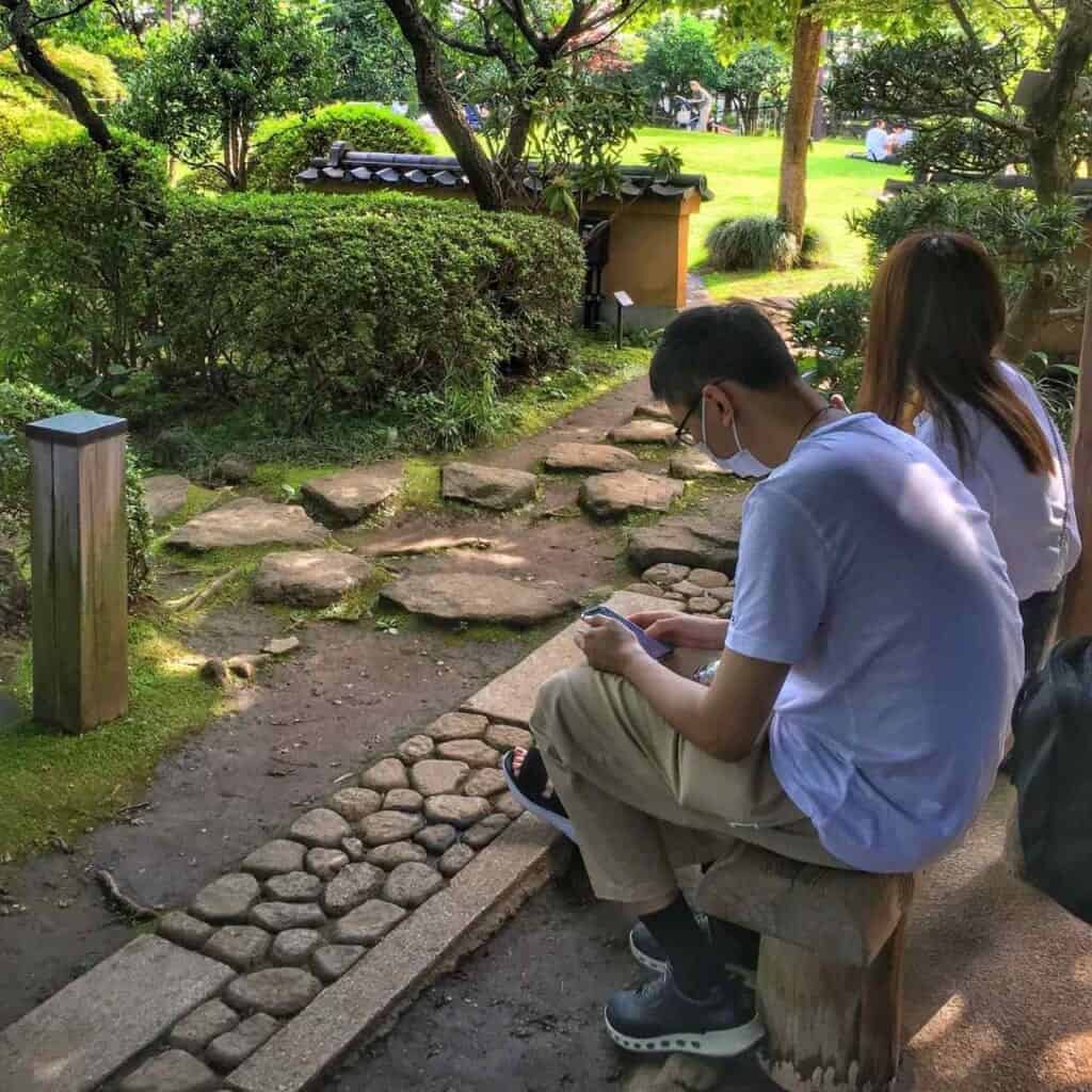 people sitting in Japanese garden