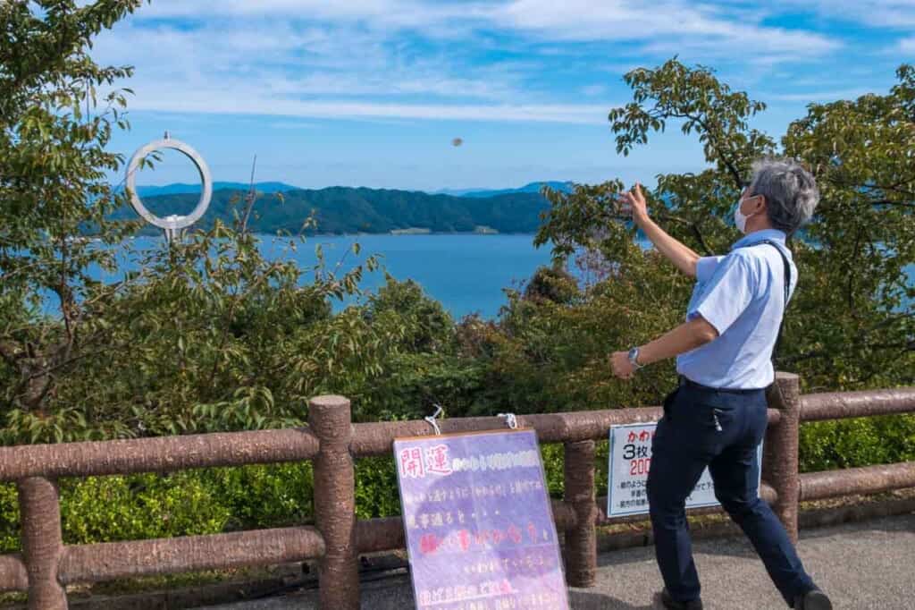 man throwing clay disc at a hoop
