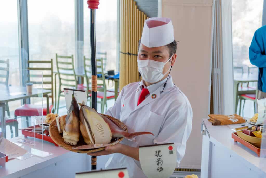 Japanese man holding fresh bamboo  in Tsuruoka, a UNESCO Creative City of Gastronomy in Japan
