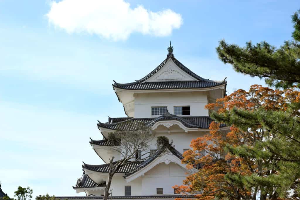 A white castle in front of a blue sky in JApan