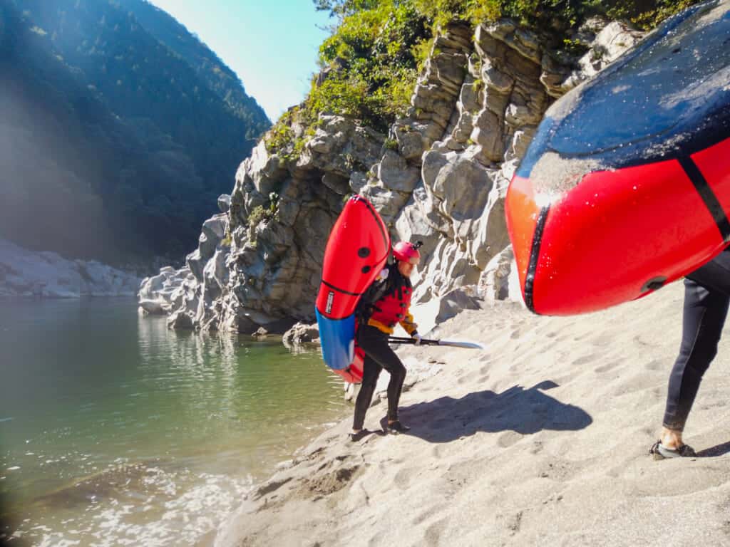man holding raft for adventure travel in shikoku