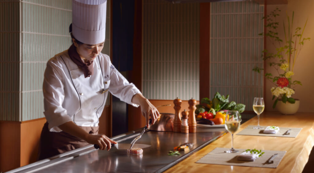 chef cooking a piece of beef teppanyaki-style