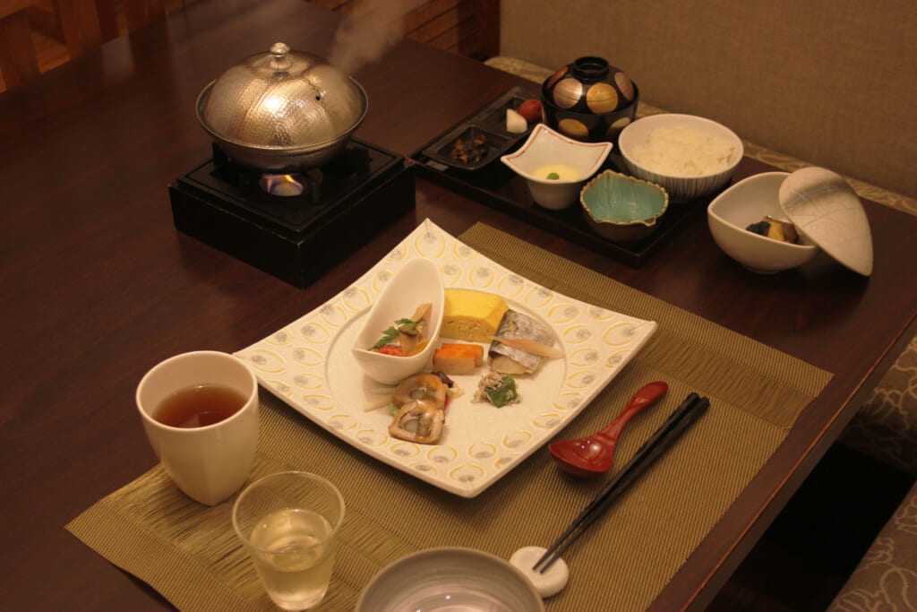 several plates filled with Japanese dishes