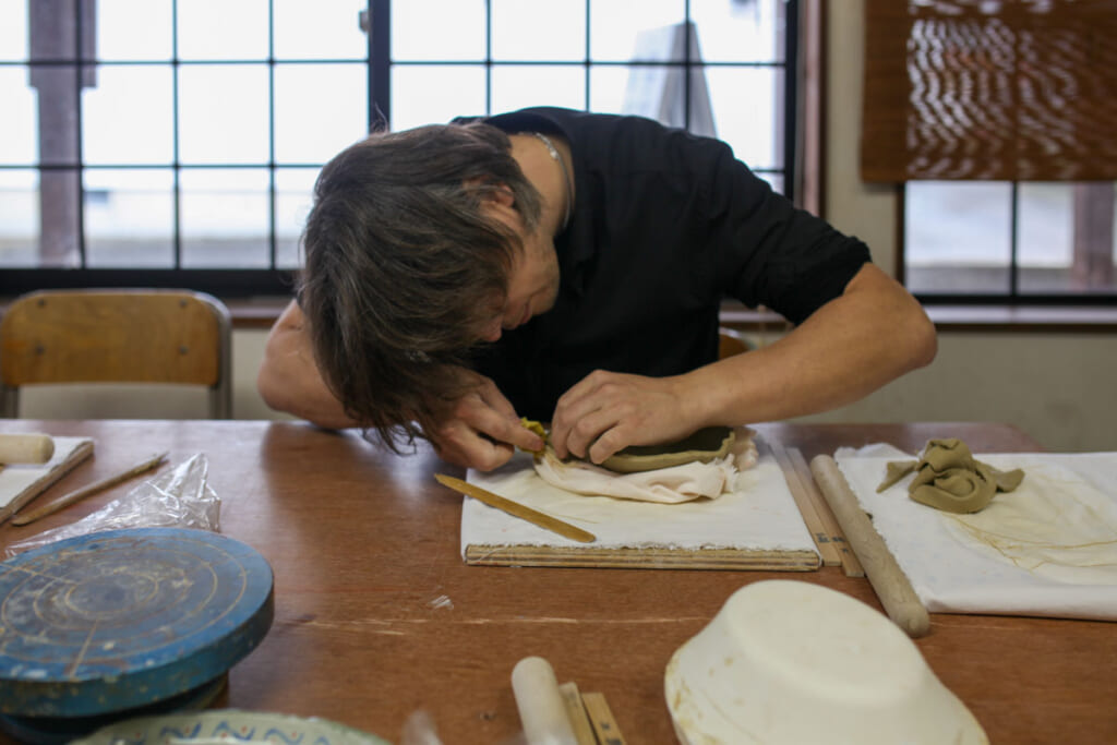 Man shaping clay in Japan