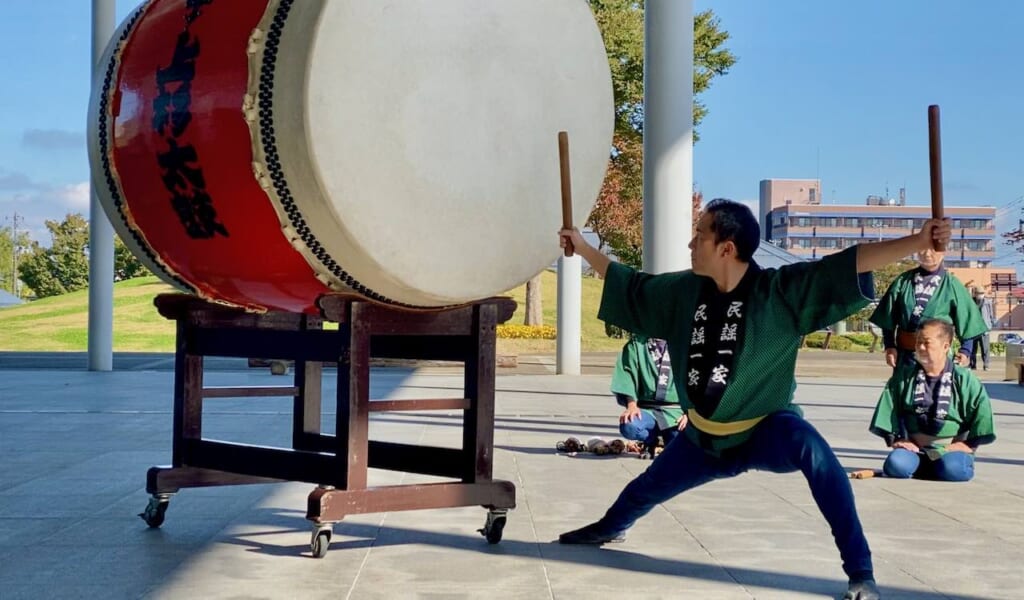 performer posed to strike the o-daiko