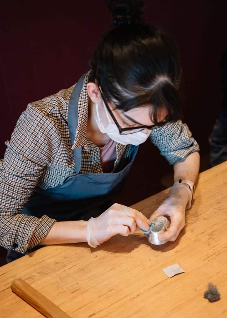woman making tin craft in japan