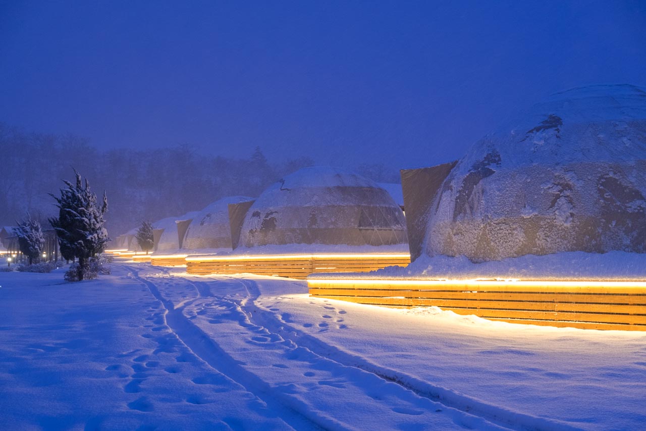 row of yurts in snow in Kyoto, Japan
