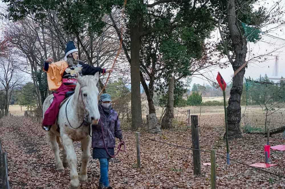 woman on  horseback trying yabusame bow and arrow