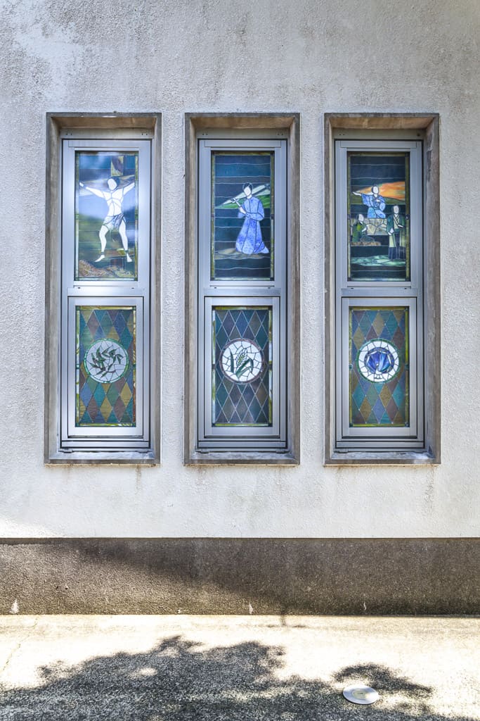 Six panels of Japanese stained glass with depictions of hidden Christians on Fukue Island, Nagasaki