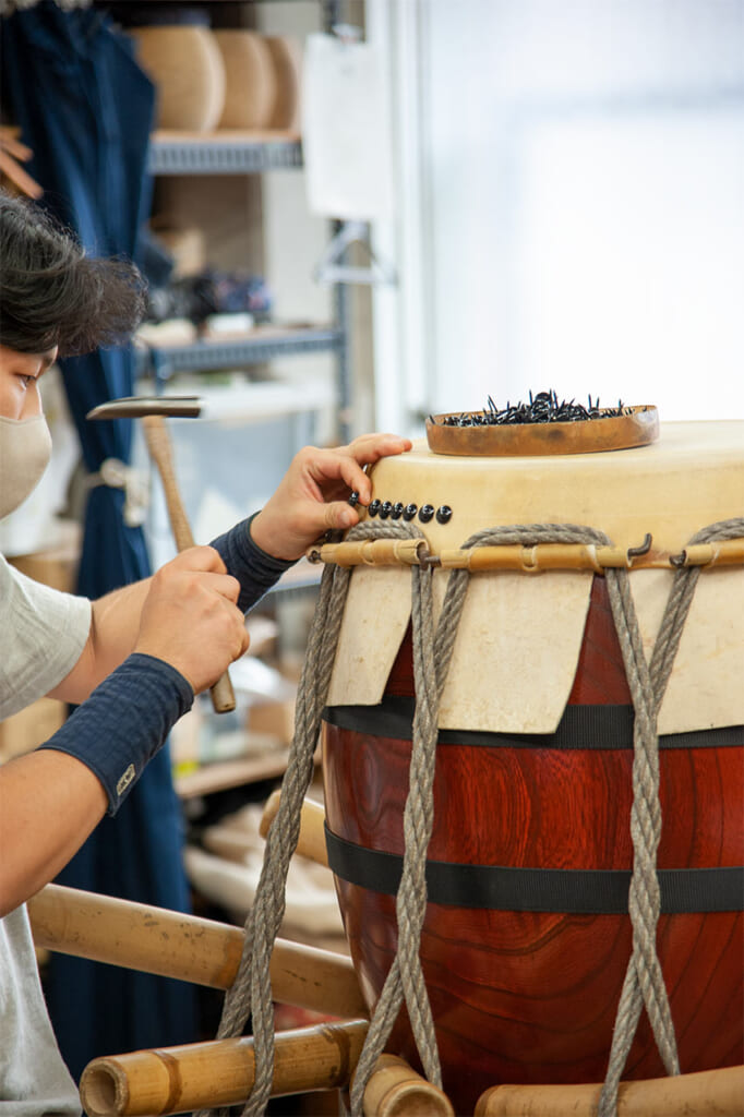 A craftsmen making a taiko drum at Miyamoto Unosuke in Asakusa, Tokyo