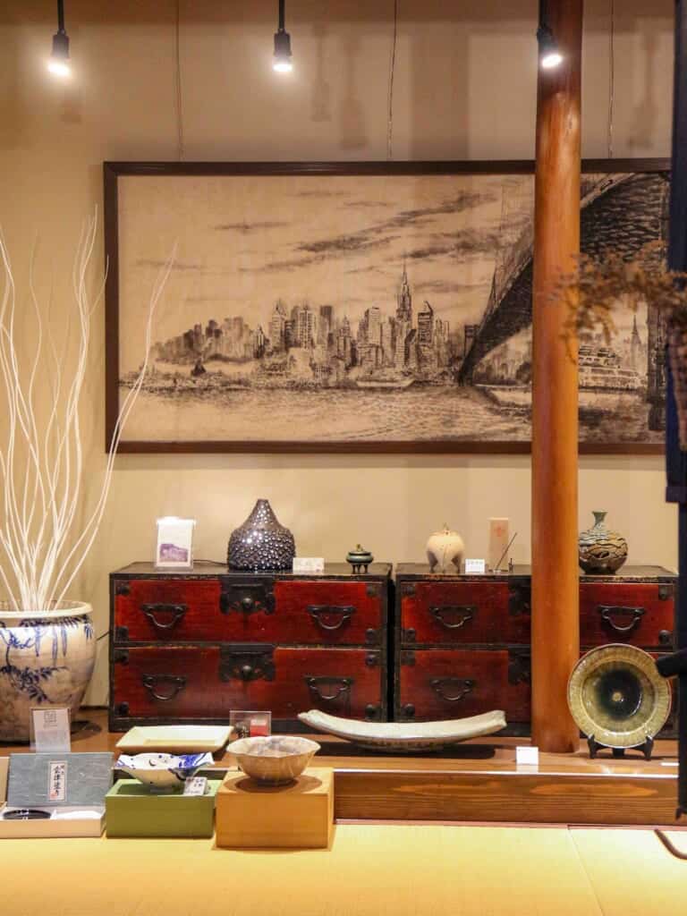 Living room wall with a large painting and 2 chests