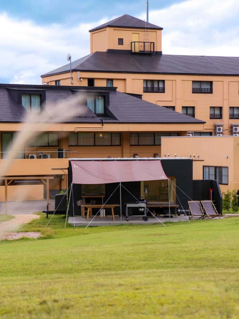 the glamping room with the hotel in the background