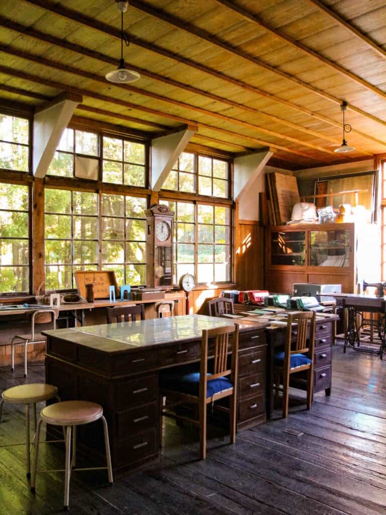 The faculty room featuring many large desks and chairs