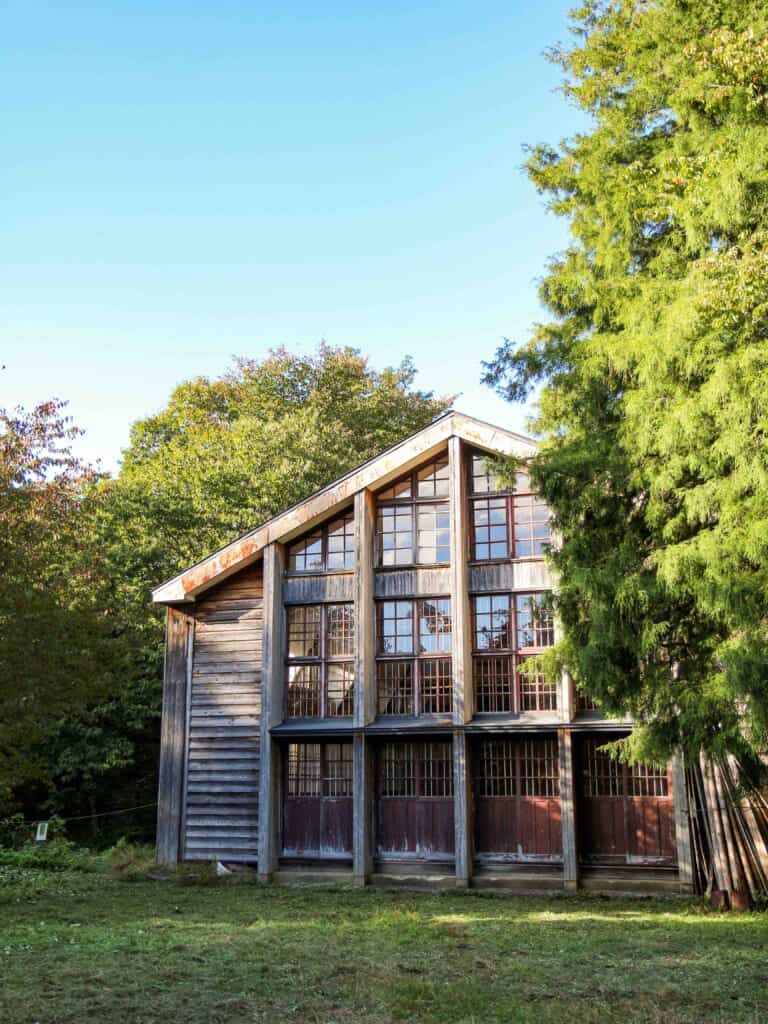 Wooden exterior of the gymnasium featuring large suqare panel windows