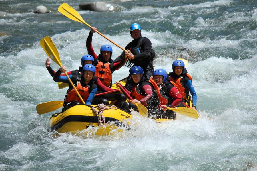 people in wetsuits white water rafting in Japan