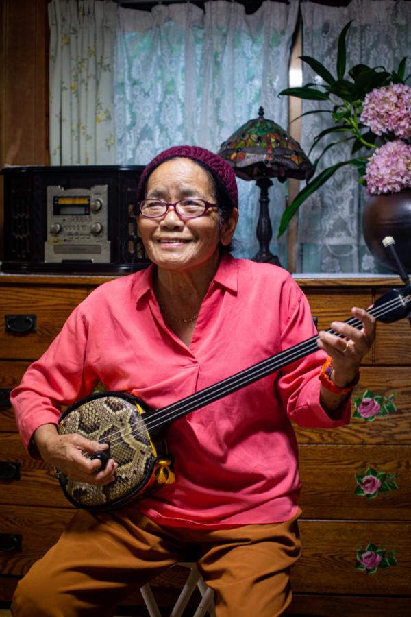 A local resident plays sanshin, Okinawas iconic instrument.