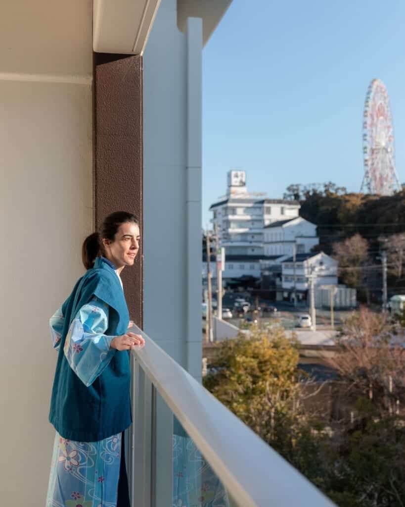 Woman looking over hotel room balcony