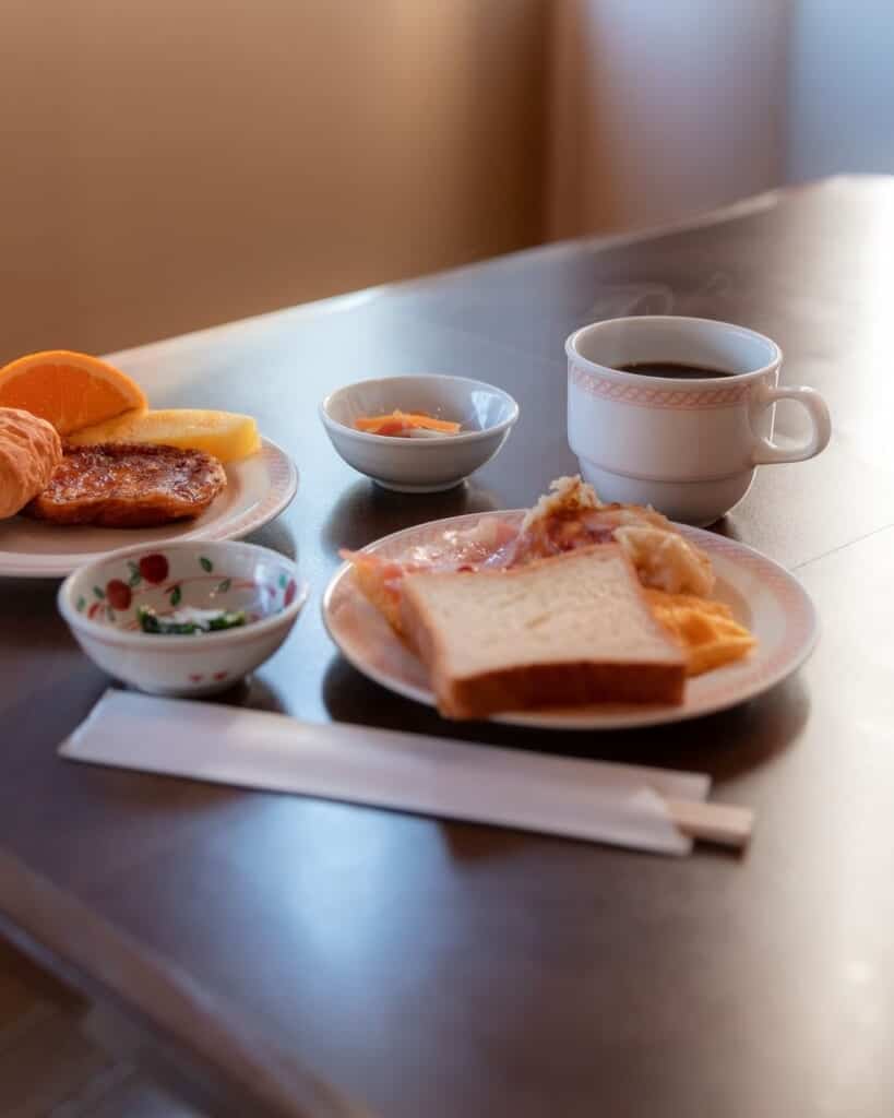 breakfast with coffee, toast, eggs, and fruits