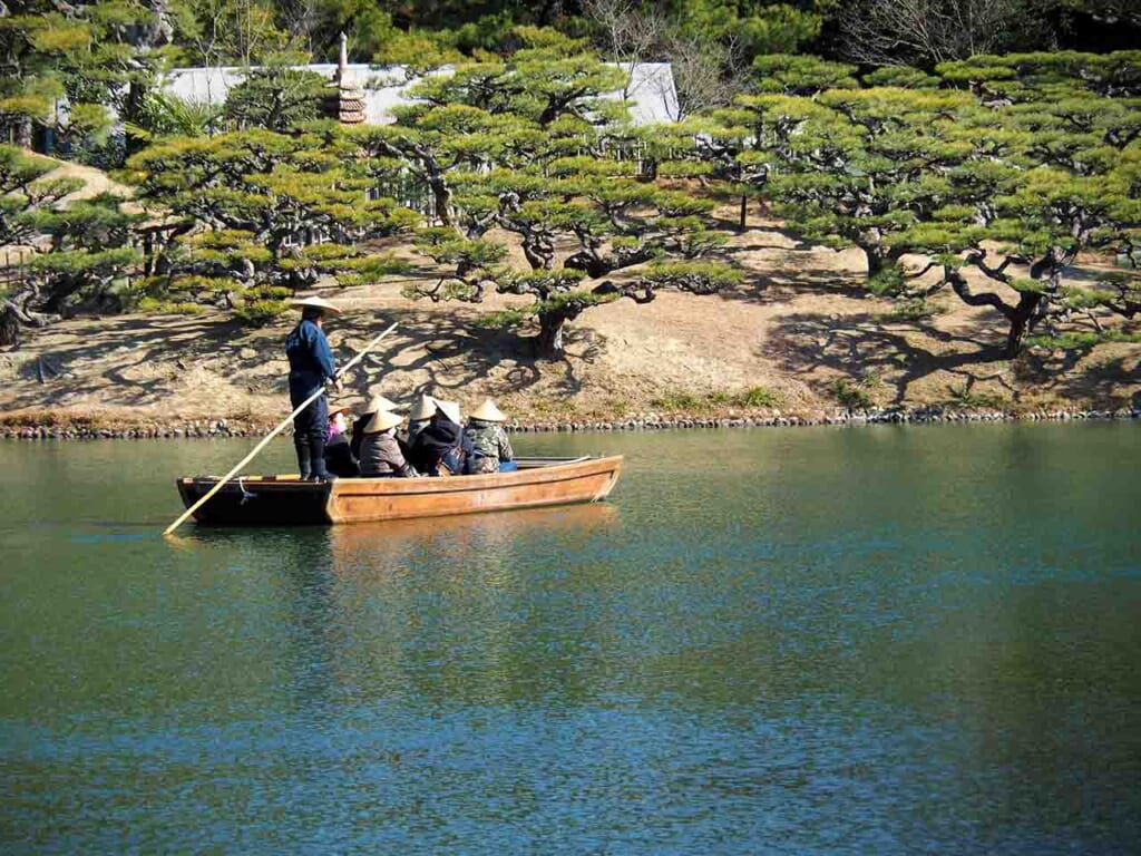 A Japanese Wasen boat floats on the waters on the Ritsurin Garden pond