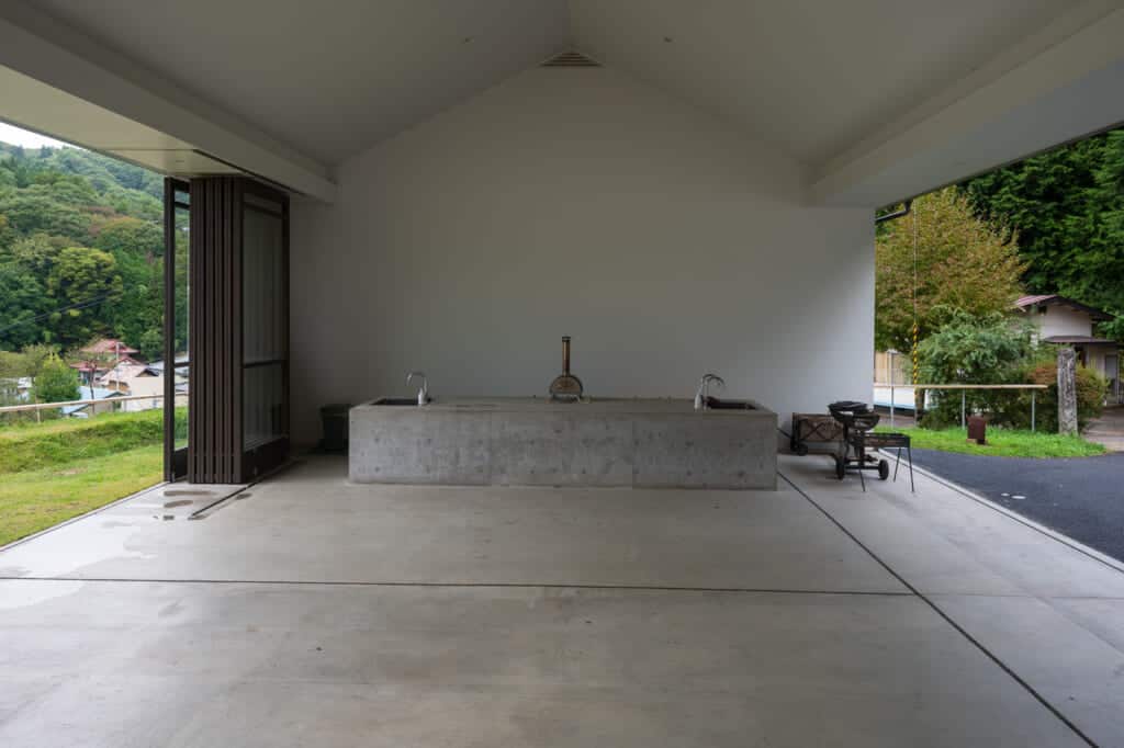 cement building with two walls open to outside nature