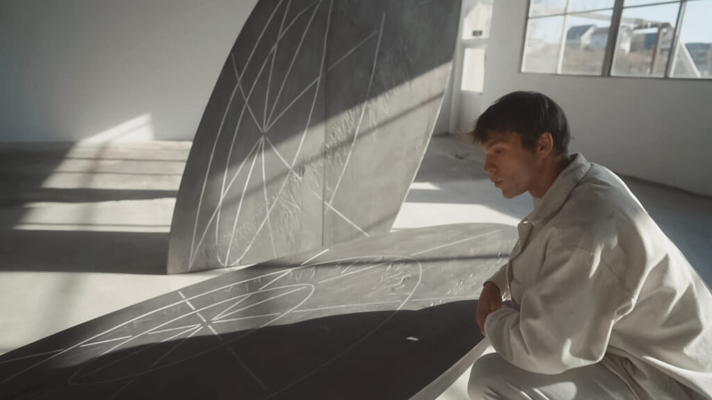 Person sitting infront of artwork