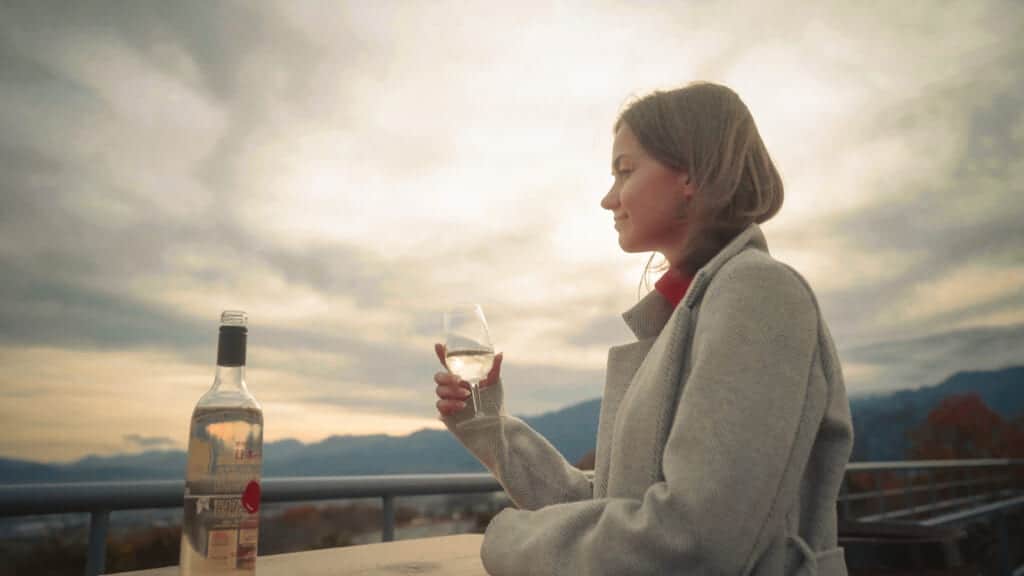 female drinking wine outside