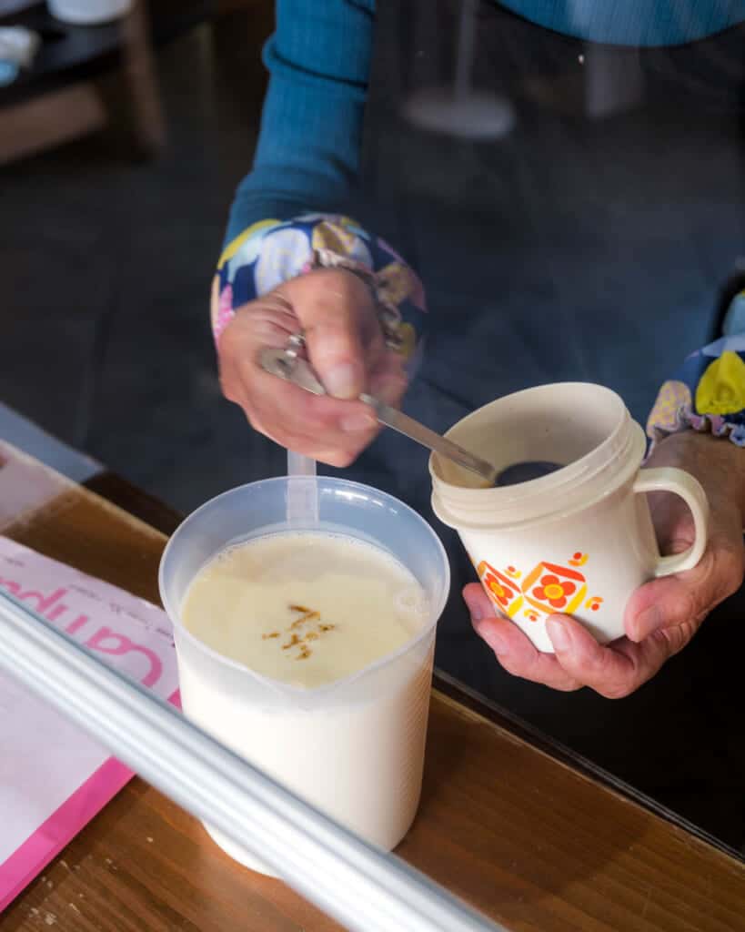 woman dripping soy sauce into ice cream