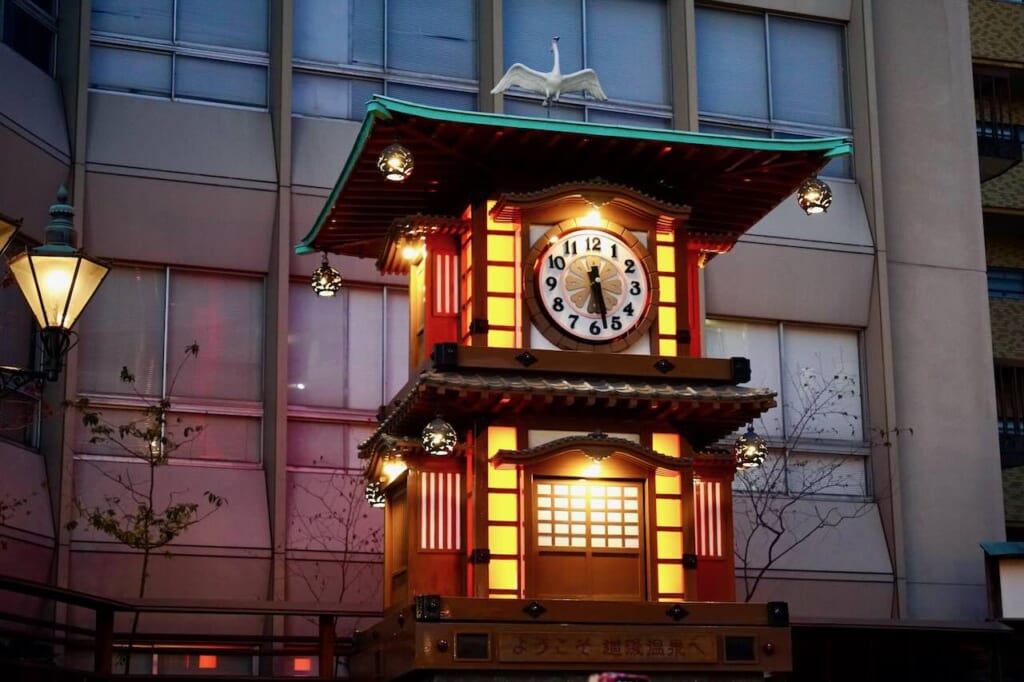 Botchan Karakuri Clock lit up at dusk