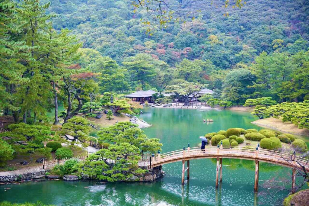 overview of Ritsurin Garden with bridge and tea house in background