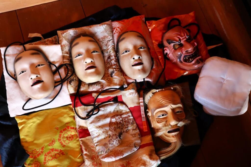 various noh masks laid out on floor