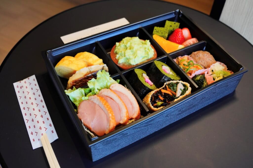 Bento breakfast with matcha items, duck, and mackerel sushi at a hotel in Kyoto