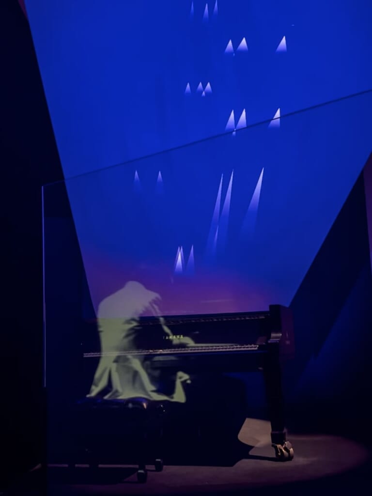 A projection of Sakamoto playing at Ars Electronica '97 uses MIDI data to generate images based on tunes as part of "Ryuichi Sakamoto | seeing sound, hearing time" installation.