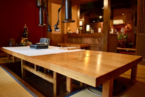 Grande table en bois dans un espace privatif du restaurant Farmer à Ubuyama, Kumamoto