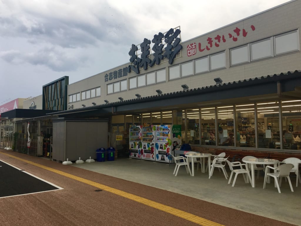 Façade du magasin Shikisaisai, devant lequel sont disposés tables et chaises