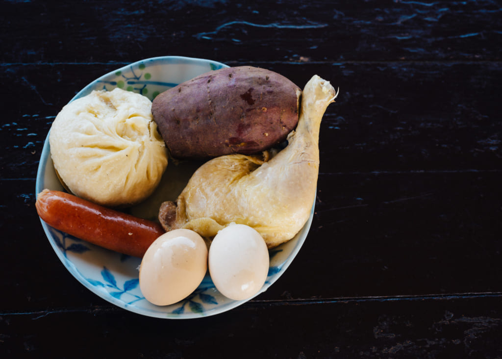 Repas cuis à la vapeur de l'onsen : poulet, patate douce, brioche au porc, saucisse et œufs